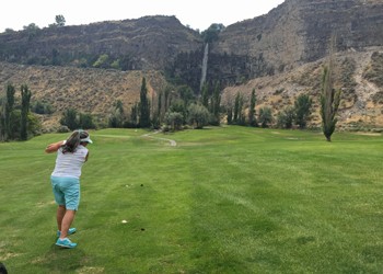 Becky takes a swing while I admire the waterfall spilling into the gorge